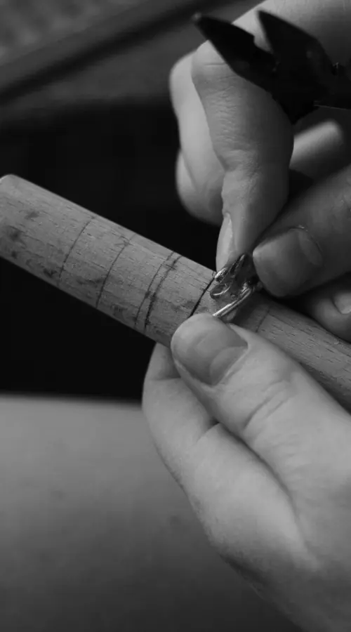Shaping a silver ring on a mandrel
