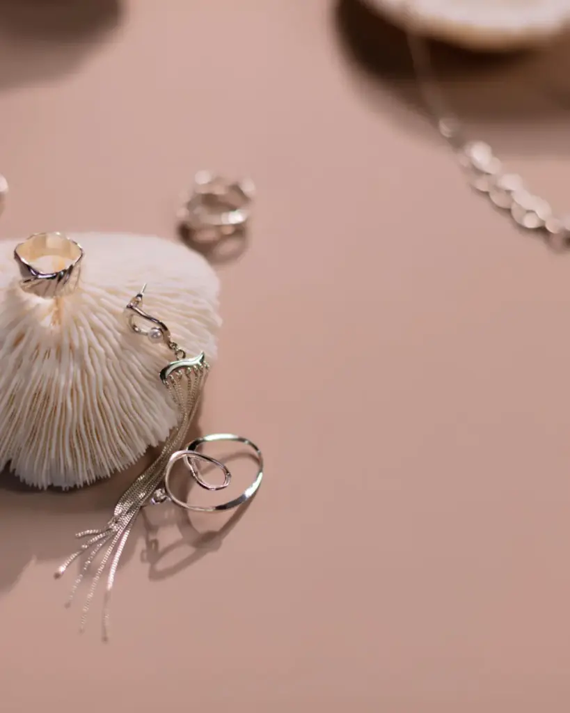 Silver rings on a soft pink surface
